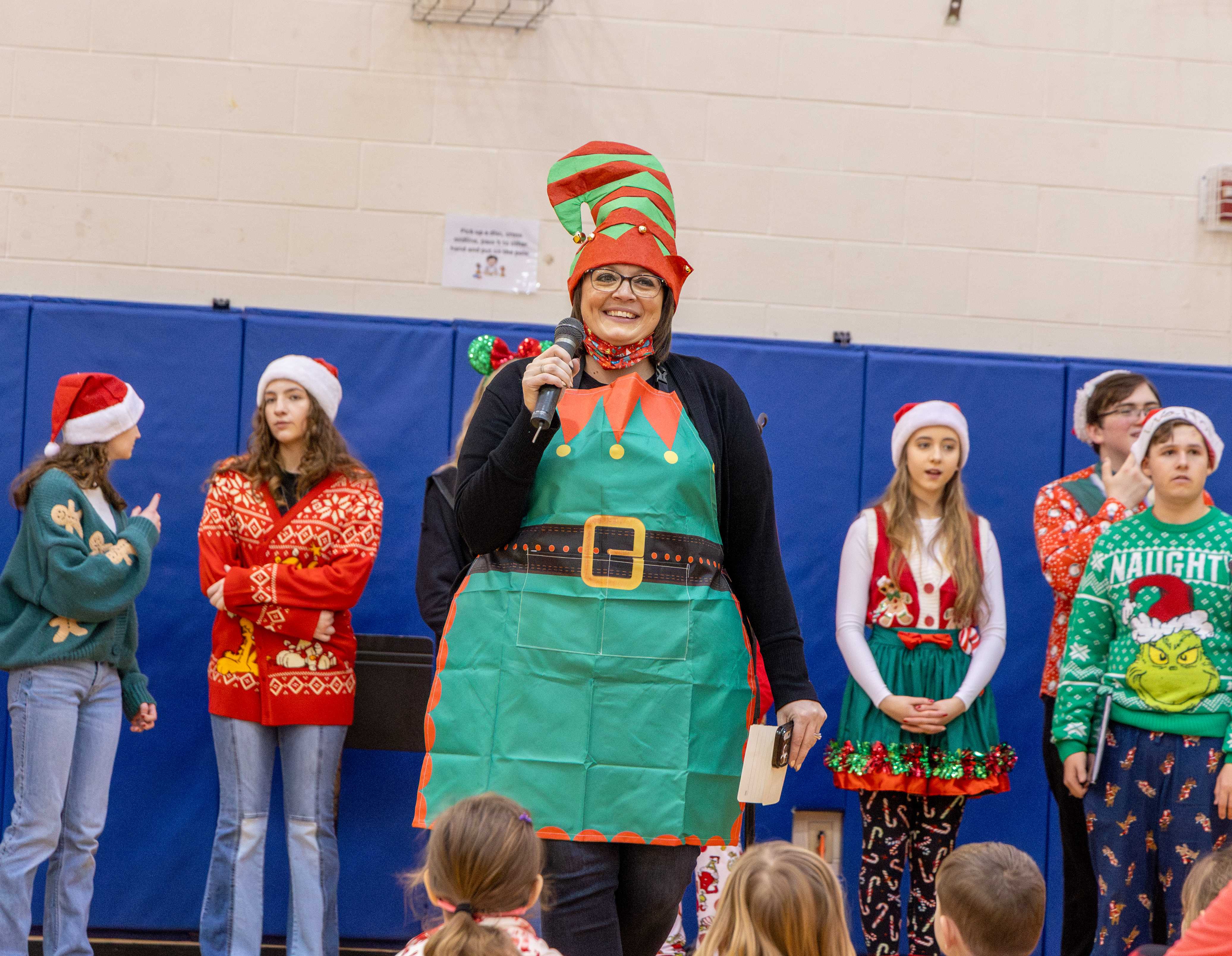 Principal Westfall smiles to the crowd of Ryder students, dressed in a festive elf outfit